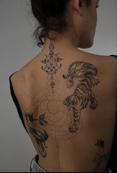 a woman with a tiger tattoo on her back