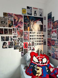 a bedroom with posters on the wall and a bed in front of it that has a stuffed animal