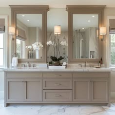 a large bathroom with double sinks and mirrors