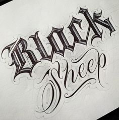 some type of lettering that is on top of a piece of paper with the words black sheep