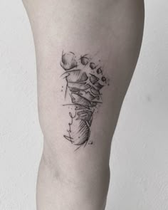 a woman's leg with a small tattoo on the left side of her thigh