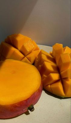 there are two pieces of mango on the plate