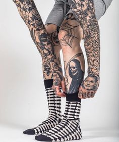 a person with tattoos on their legs and leggings