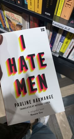 the book i hate men by pauline harmon is held up in front of bookshelves