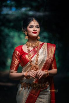 Photo of An elegant bridal shot in Bengali saree and temple jewellery. Bengali Saree