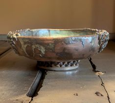 a metal bowl sitting on top of a table