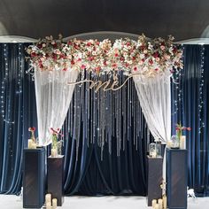 a wedding stage decorated with flowers and beads