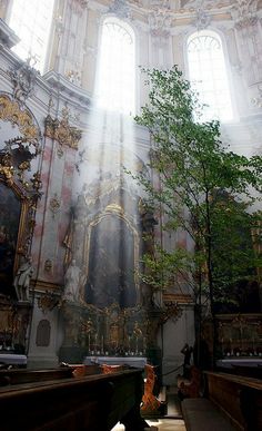 the sun shines through two windows in an ornate building