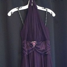 a purple dress hanging up on a hanger