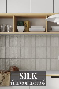 a kitchen with white cupboards and shelves filled with dishes on top of counter tops