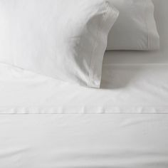 white sheets and pillows on top of each other