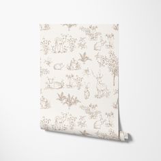 a wallpaper with animals and plants on it in beige, cream or white colors