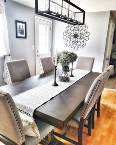 a dining room table with chairs and a chandelier