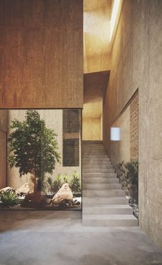 a staircase leading to the upper level of a house with stone walls and flooring