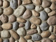 a stone wall with various colored rocks on it