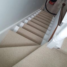 there is a carpeted stair leading up to the second floor