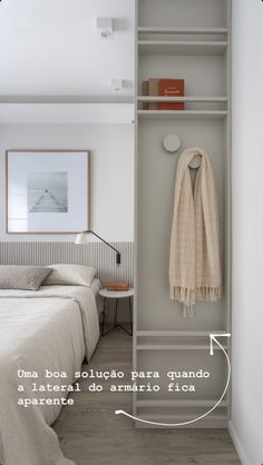 a bed room with a neatly made bed and a towel hanging on the wall next to it