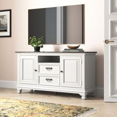 a white entertainment center with a large mirror on top