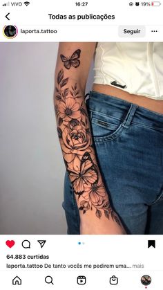 a woman's arm with flowers and butterflies on it