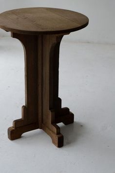 a wooden table sitting on top of a white floor