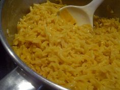 macaroni and cheese being stirred in a pot