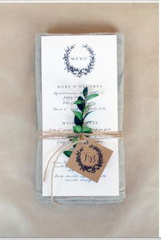 the wedding stationery is tied up with twine