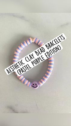 a purple and blue bracelet with the words aesthetic clay bead bracelets on it