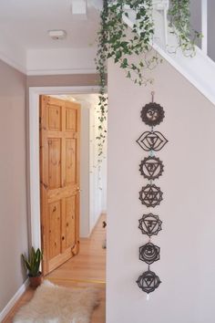 an entry way with plants and decorations on the wall