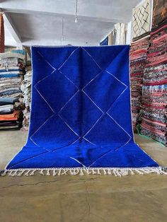 a large blue rug is on display in a store