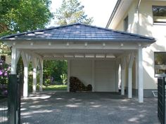 a white gazebo sitting in the middle of a driveway