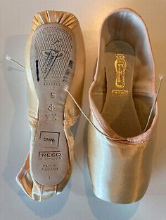 a pair of ballet shoes sitting on top of a white floor