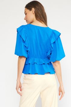 Spice up your wardrobe with this playful blue bubble sleeve peplum top! Featuring a V-neckline, ruffle tiers, and lightweight woven fabric, this top is both stylish and comfortable. Perfect to dress up or throw on with jeans or shorts. The non-sheer lining adds an extra layer of coverage, making it perfect for everyday wear. Don't miss out on this trendy addition to your closet! Shown with out Farrah Skirt Size and Fit: Emily is 5'1" and in a small, stock model is 5'9" and also in a small Summer V-neck Peplum Top With Ruffle Hem, Spring V-neck Puff Sleeve Top With Ruffles, Chic Blue V-neck Top For Spring, Chic Blue V-neck Top For Summer, Spring V-neck Peplum Top With Ruffle Hem, Chic V-neck Peplum Top With Ruffles, Spring Chic V-neck Peplum Top, Trendy Tops With Ruffle Hem For Brunch, Spring Ruffled Tops For Brunch