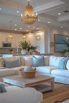 a living room filled with lots of furniture and a chandelier hanging from the ceiling