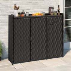 an outdoor storage cabinet with drinks on top