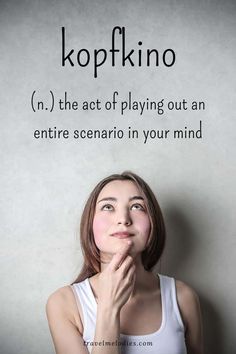 a woman standing in front of a wall with the words kopkino on it