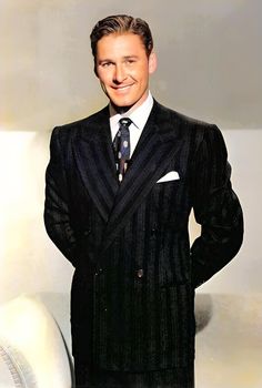 a man in a suit and tie posing for a photo