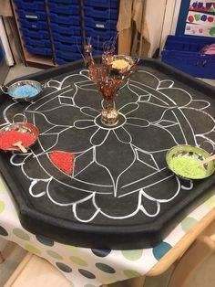 a black table topped with plates and bowls