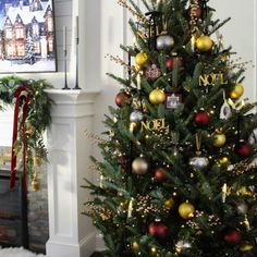 a decorated christmas tree in front of a fireplace