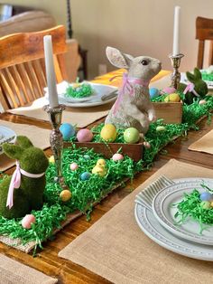 an easter table setting with bunny figurines and candles