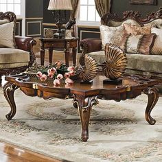 a living room filled with lots of furniture and flowers on top of a coffee table