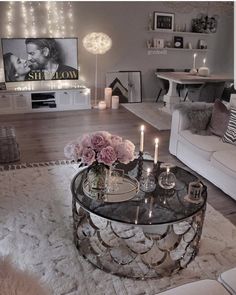 a living room filled with furniture and candles