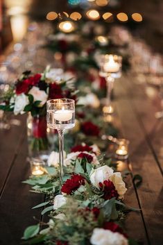 a long table with candles and flowers on it