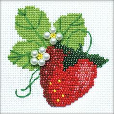 a red strawberry with green leaves and white pearls on it's side, in the shape of a cross stitch pattern