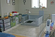 a caged in room with various items on the floor and around it, including a television