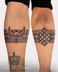 two people with tattoos on their legs and one has a crown in the middle of it