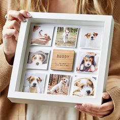 a woman holding up a white frame with pictures of dogs on it and the words buddy written in wood