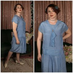 Vintage 1920s day dress in a soft, pliable and lustrous lightweight blue silk. This is a classic 20s look with drop waist and little attached scarf detail. Some elements are simple - the short sleeves, the rounded neckline. The bodice is crossed with three sets of pintucks rows, and the drop waist is a deep pleat of self-fabric at the front, and softly draped "sash at the back. The skirt has some pleats at the center front to give it a little movement.  The neckline accent is absolutely my favorite part - an attached v shape, with three amber hued glass buttons above the asymmetric jabot. This cute frock slips over the head and has no closures.  ✂-----Measurements Bust: 43" Drop Waist: 42 " Hips: 44" Length: 41" Shoulder to Drop Waist: 20"  Label: None Present Material: Silk Condition: Goo 1920s Style Fitted Daywear Dresses, Vintage 1920’s Dresses, Blue 1920s Dress, 1920s Daywear, 1920s Day Dress, 1920s Extant Dress, Dresses Elegant, 1920s Dress, Pin Tucks