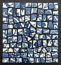 a blue and white mosaic tile on a black background