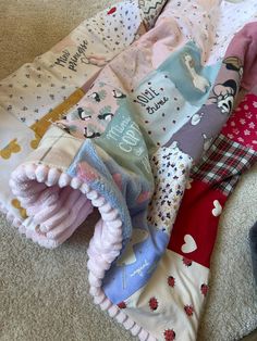 a pile of children's clothing laying on the floor