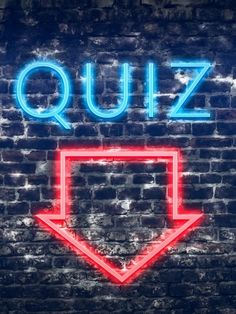 a neon sign that says quiz on the side of a brick wall with an arrow pointing up